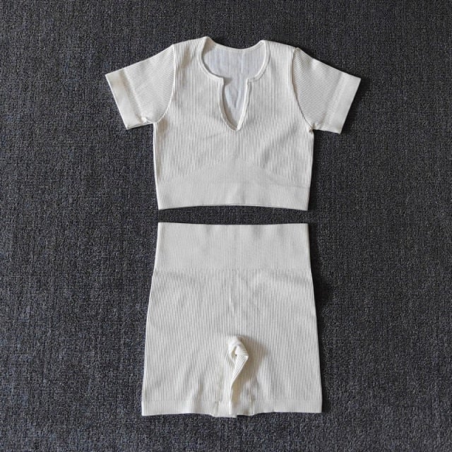 A stylish Seamless Yoga Set for women featuring a short sleeve crop top and high-waisted shorts in solid and striped patterns, perfect for workouts.