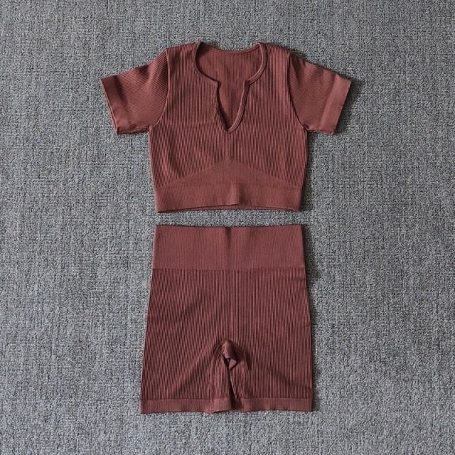A stylish Seamless Yoga Set for women featuring a short sleeve crop top and high-waisted shorts in solid and striped patterns, perfect for workouts.