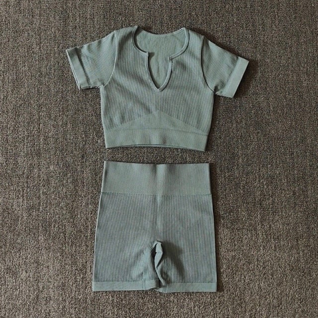 A stylish Seamless Yoga Set for women featuring a short sleeve crop top and high-waisted shorts in solid and striped patterns, perfect for workouts.
