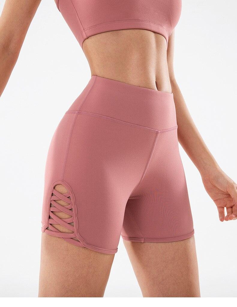 Women wearing high waist side cross strap fitness sport shorts in a gym setting, showcasing comfort and style during workout.