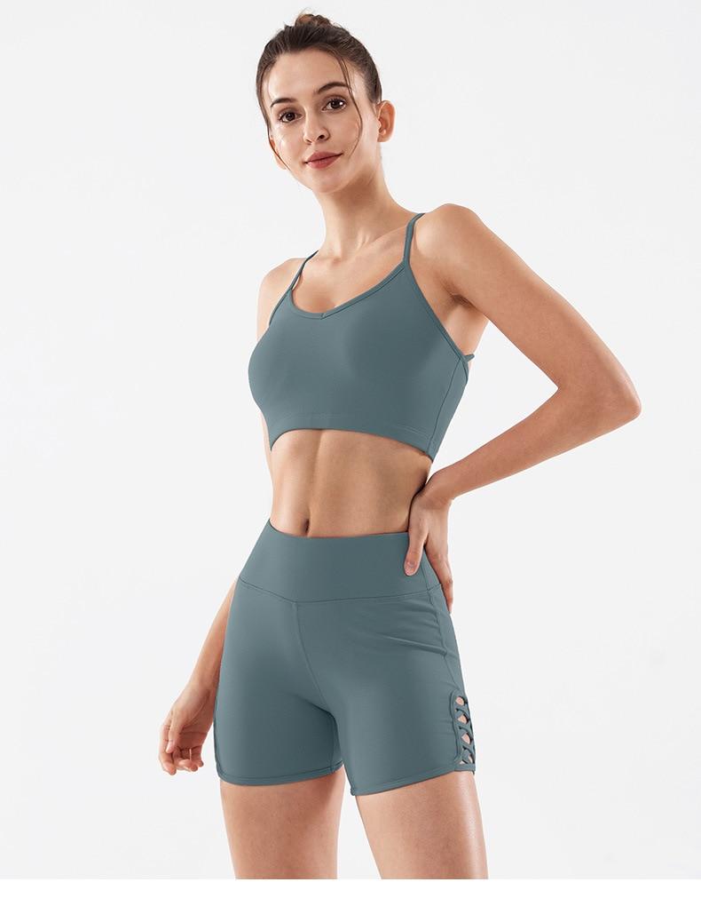 Women wearing high waist side cross strap fitness sport shorts in a gym setting, showcasing comfort and style during workout.