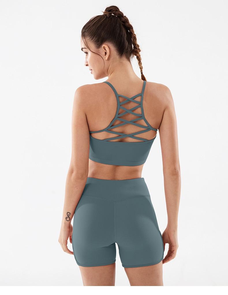 Women wearing high waist side cross strap fitness sport shorts in a gym setting, showcasing comfort and style during workout.