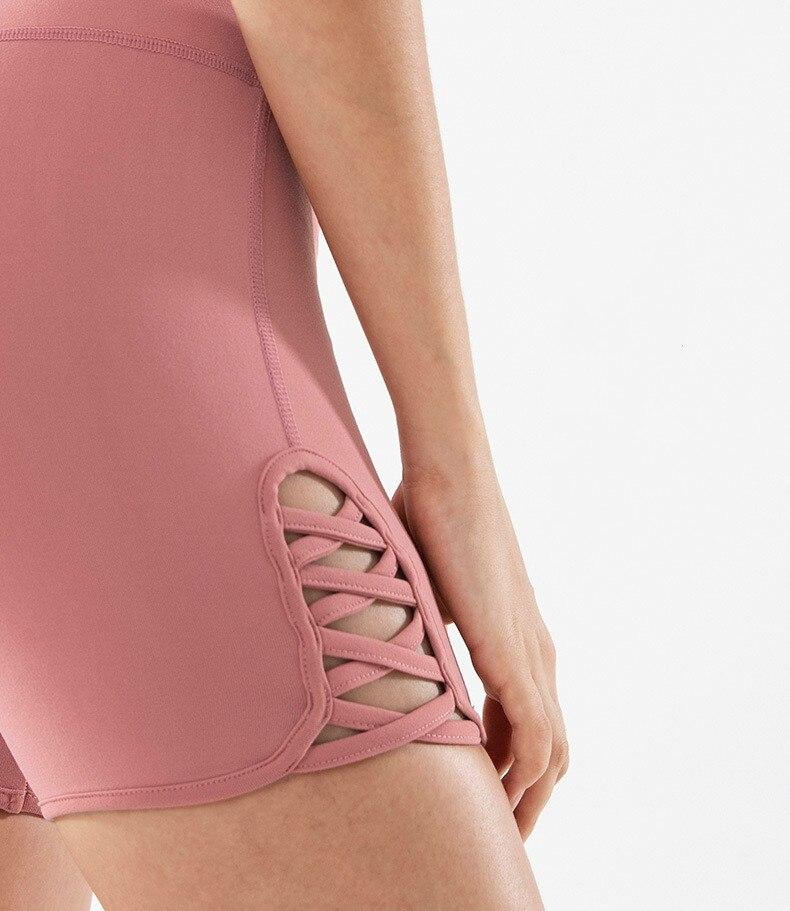 Women wearing high waist side cross strap fitness sport shorts in a gym setting, showcasing comfort and style during workout.