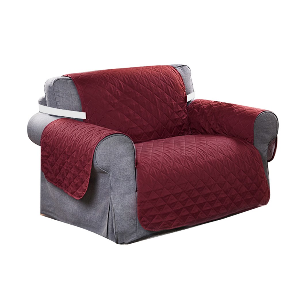 Waterproof quilted sofa cover in wine color, designed for protection and style, featuring delicate edges and anti-slip backing.