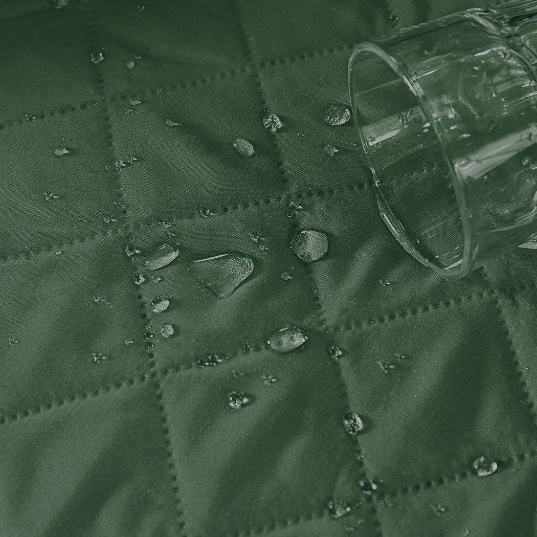 Waterproof quilted sofa cover in coffee color, designed for protection and style, featuring delicate edges and anti-slip backing.