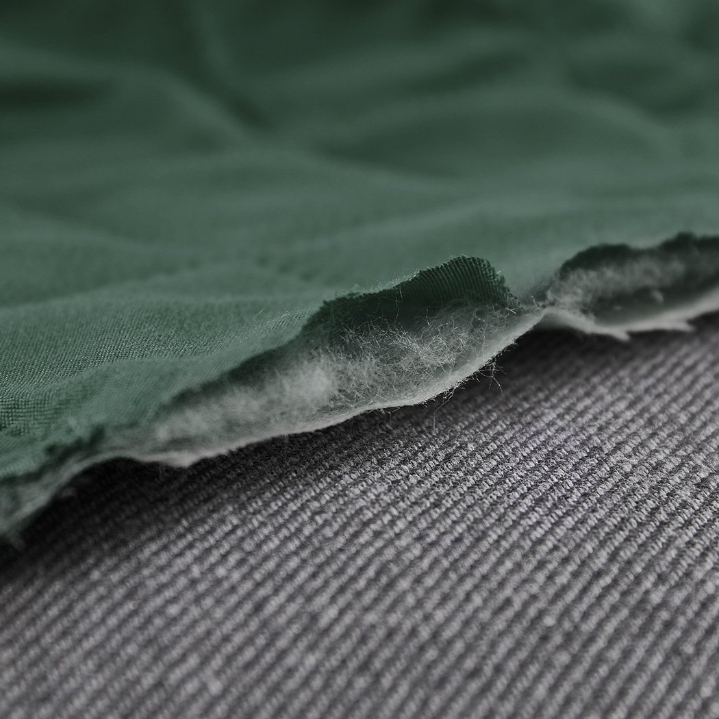 Waterproof quilted sofa cover in coffee color, designed for protection and style, featuring delicate edges and anti-slip backing.