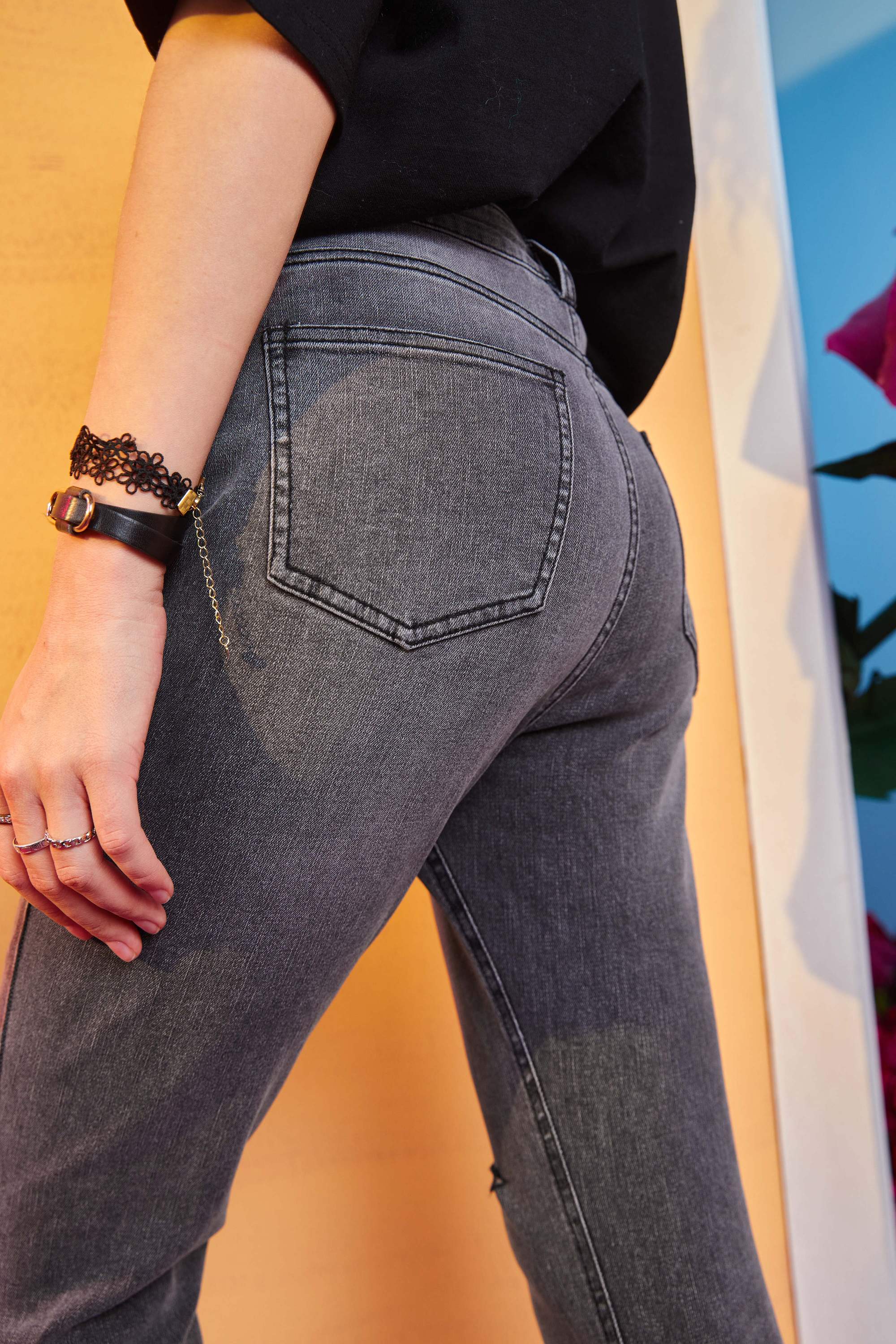 Solid high waist washed casual denim jeans for women, featuring a chic ripped hole design, available in blue and black.