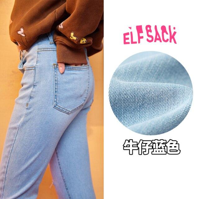 Solid high waist washed casual denim jeans for women, featuring a chic ripped hole design, available in blue and black.