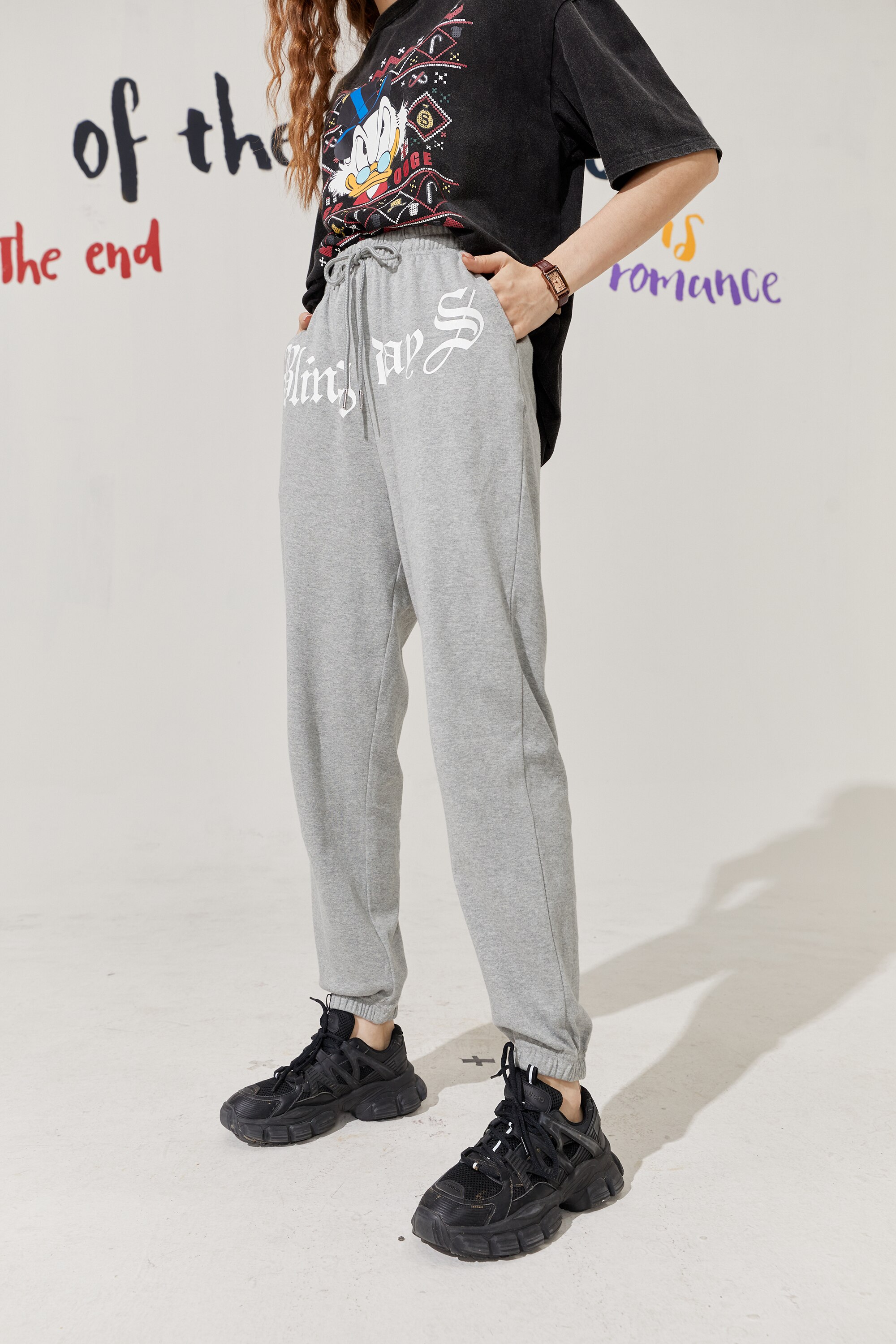 Solid Letter High Waist Straight Casual Women Harem Trouser in a stylish autumn setting, showcasing its high waist and comfortable fit.