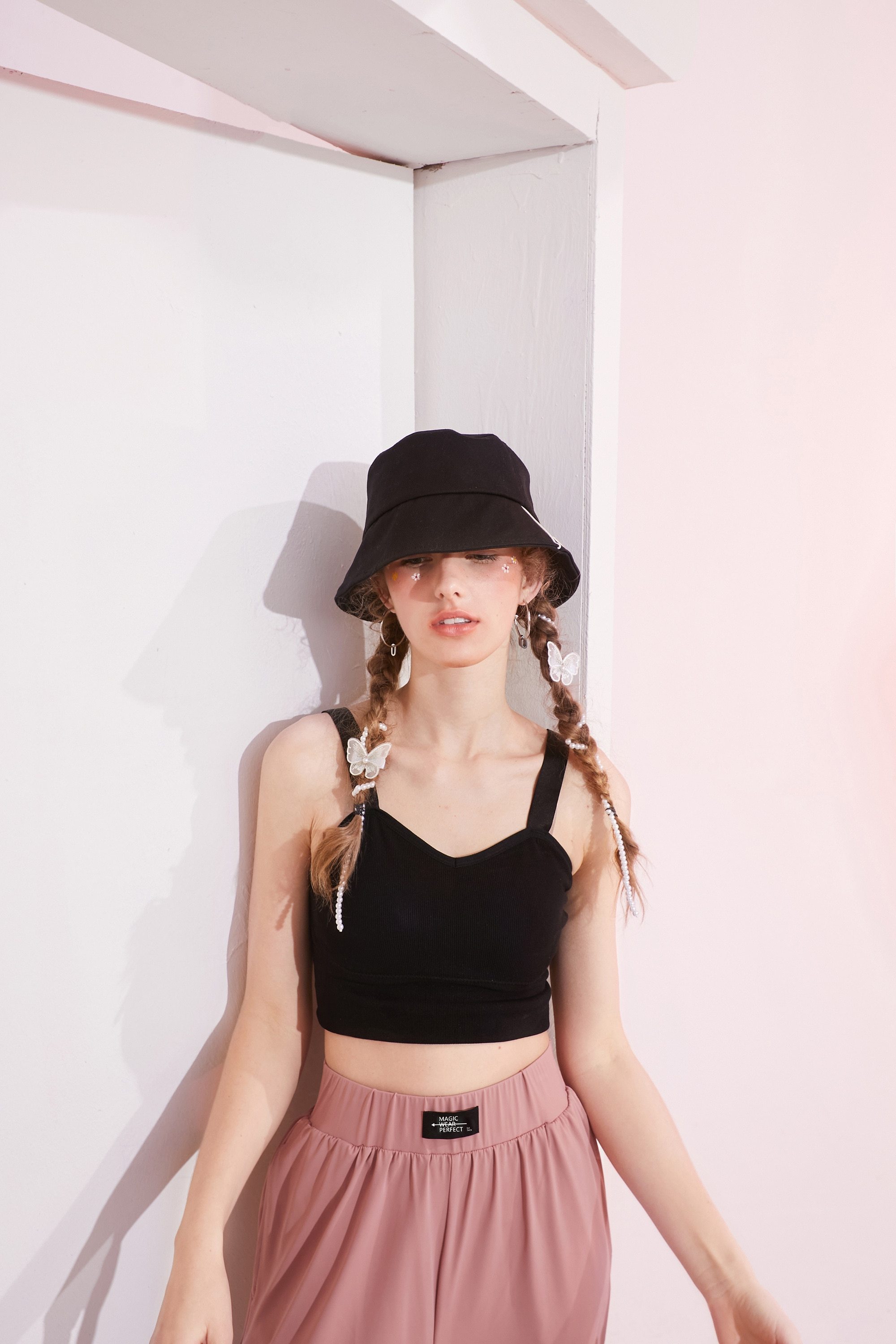 A stylish black and white crop top for women, featuring a minimalist design and sleeveless cut, perfect for casual spring outfits.