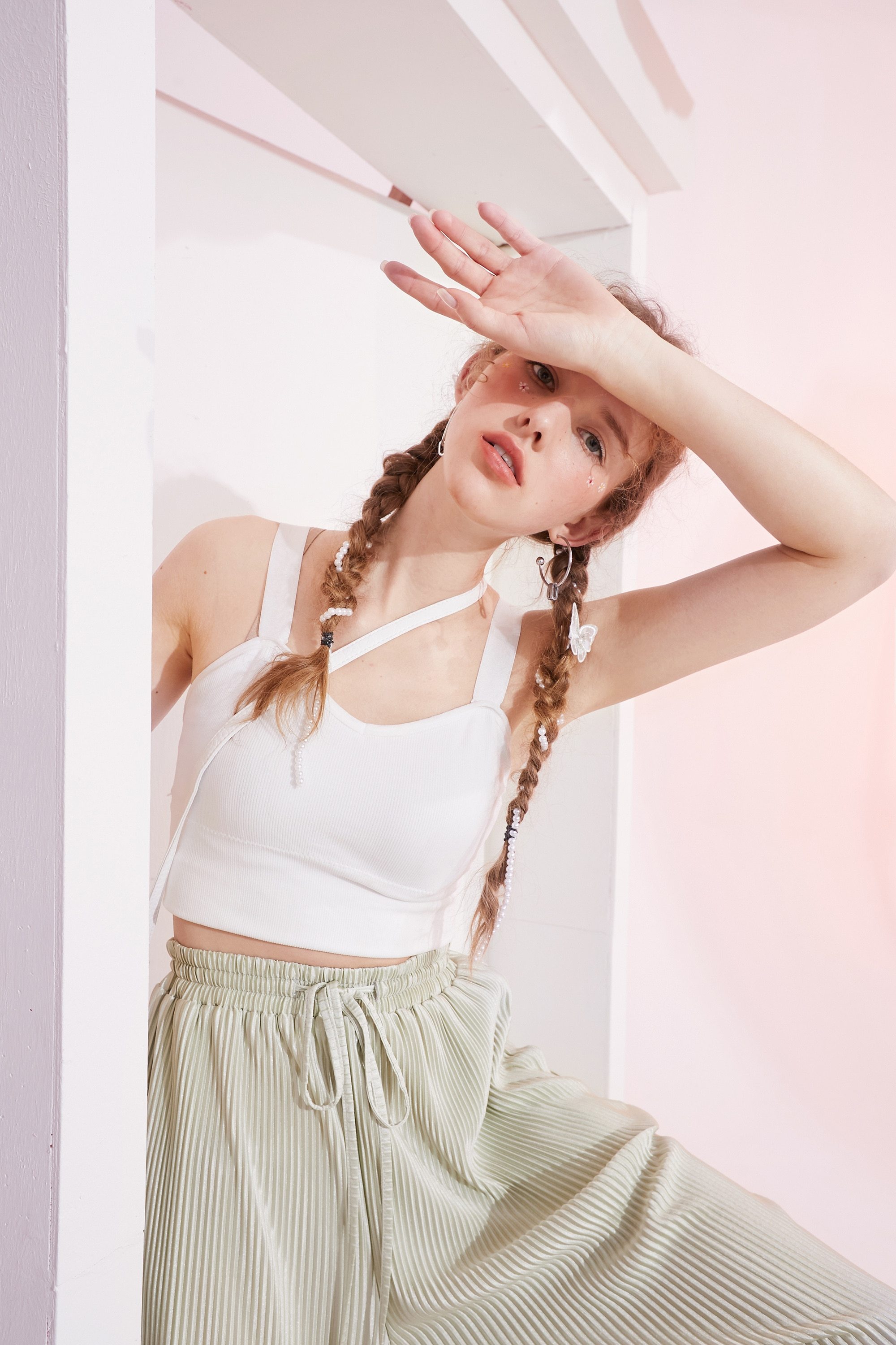 A stylish black and white crop top for women, featuring a minimalist design and sleeveless cut, perfect for casual spring outfits.