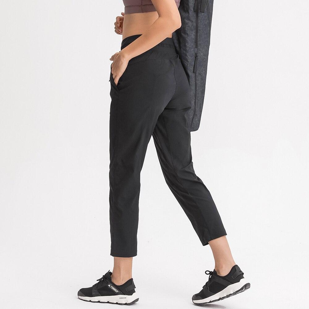 Women wearing STRIPE Mid Waist Drawstring Sport Gym Joggers, showcasing a stylish and comfortable fit for workouts.
