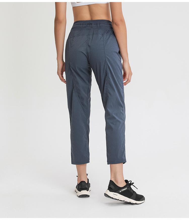 Women wearing STRIPE Mid Waist Drawstring Sport Gym Joggers, showcasing a stylish and comfortable fit for workouts.