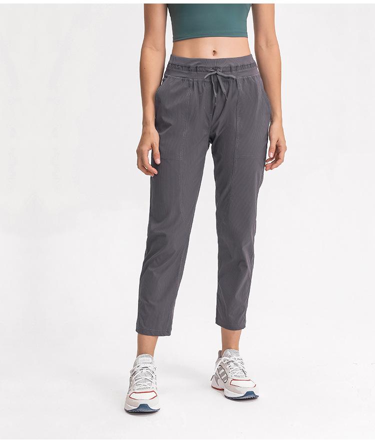 Women wearing STRIPE Mid Waist Drawstring Sport Gym Joggers, showcasing a stylish and comfortable fit for workouts.