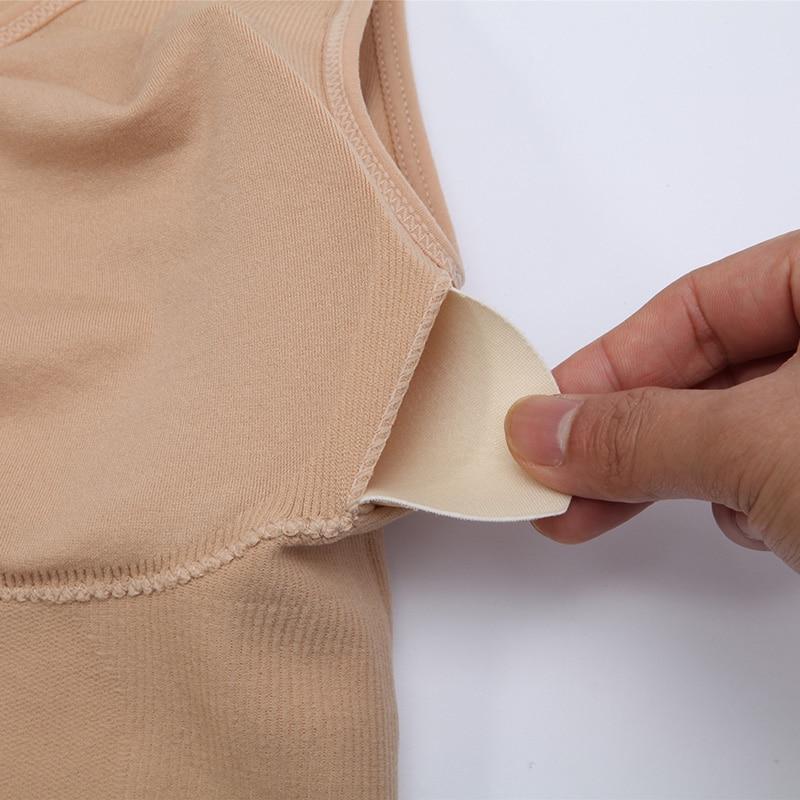 A stylish black tank top for women featuring a built-in padded shelf bra and wide straps, perfect for casual wear and active lifestyles.