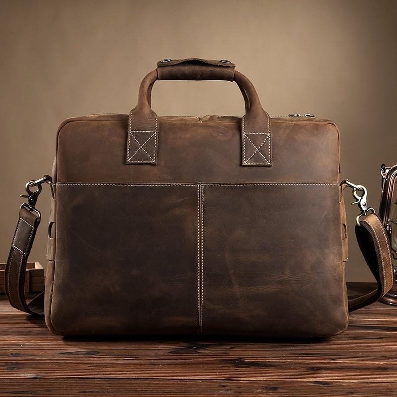 The Welch Briefcase, a vintage leather messenger bag, showcasing high-quality crazy horse leather with adjustable straps and a stylish design.