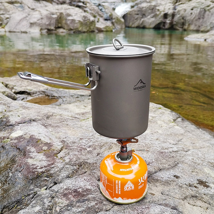A compact Titanium Mini Gas Burner camping stove, showcasing its lightweight design and portable features, ideal for outdoor cooking.