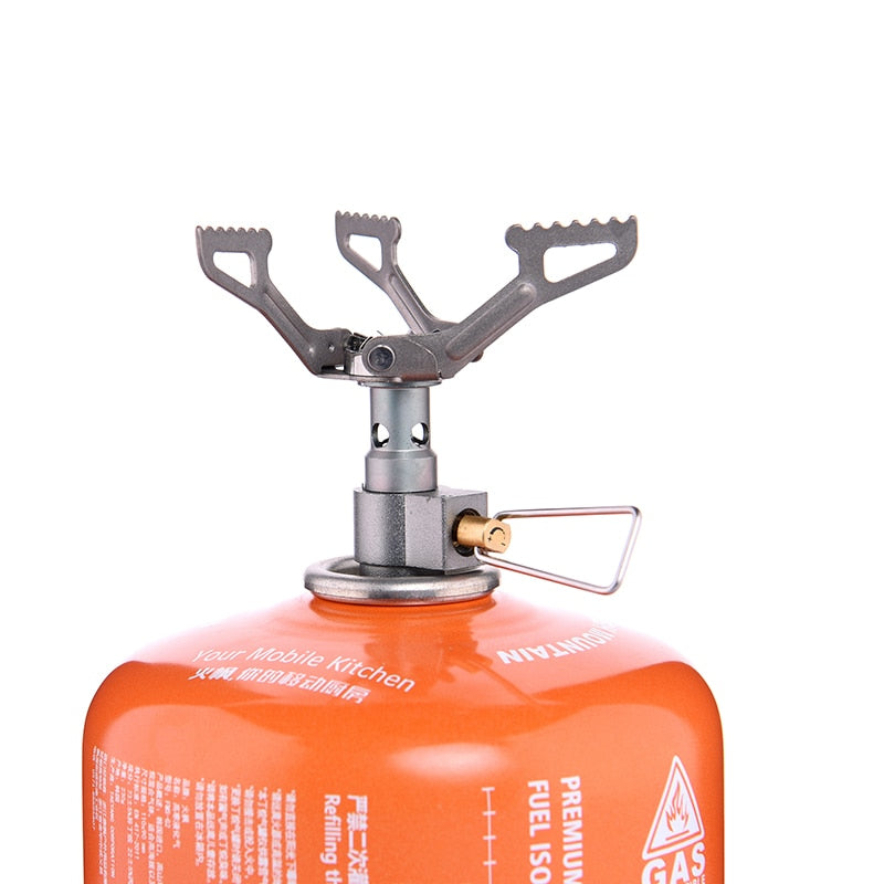 A compact Titanium Mini Gas Burner camping stove, showcasing its lightweight design and portable features, ideal for outdoor cooking.
