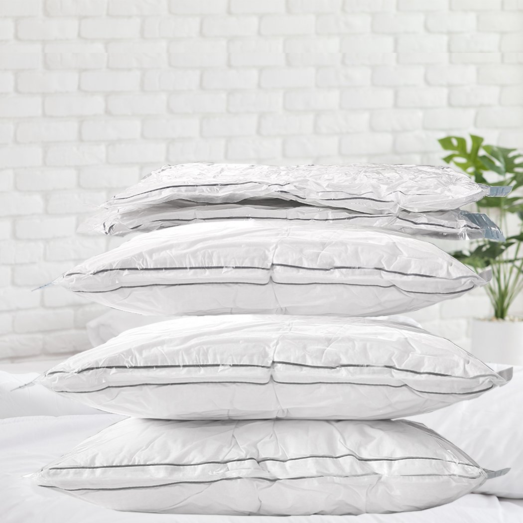 A set of six transparent vacuum storage bags filled with various clothing items, showcasing their space-saving design and airtight seal.