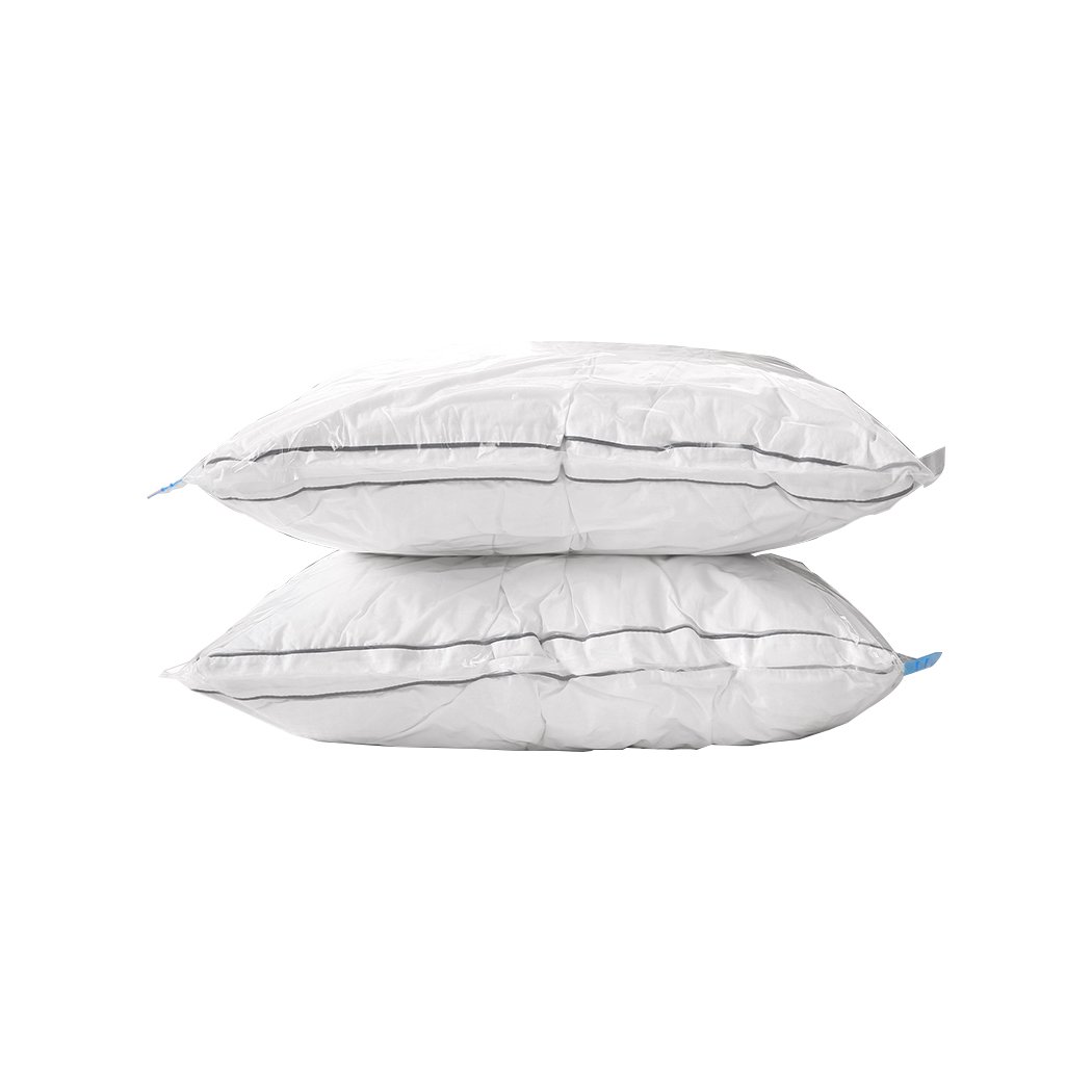 A set of six transparent vacuum storage bags filled with clothes and quilts, showcasing their space-saving design and airtight seal.