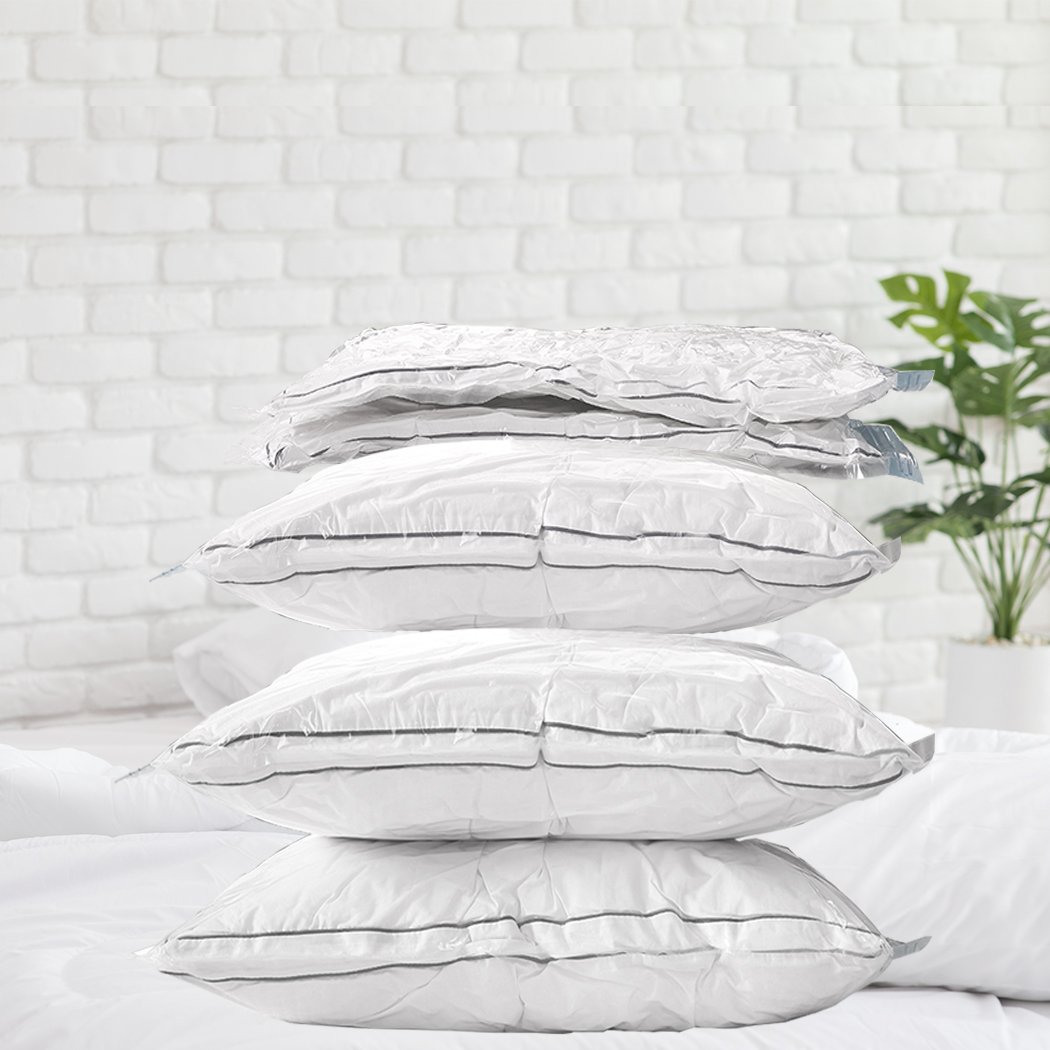 A set of six transparent vacuum storage bags filled with clothes and quilts, showcasing their space-saving design and airtight seal.