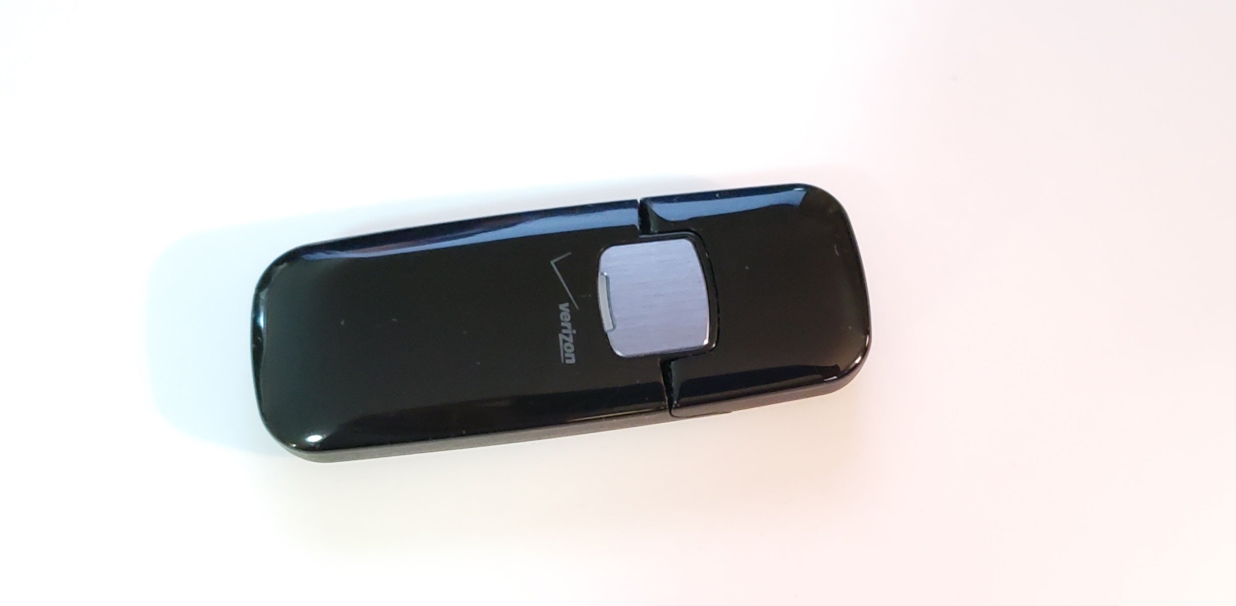 Verizon LG VL600 4G USB Mobile Broadband Modem in black, showcasing its sleek design and USB connection.
