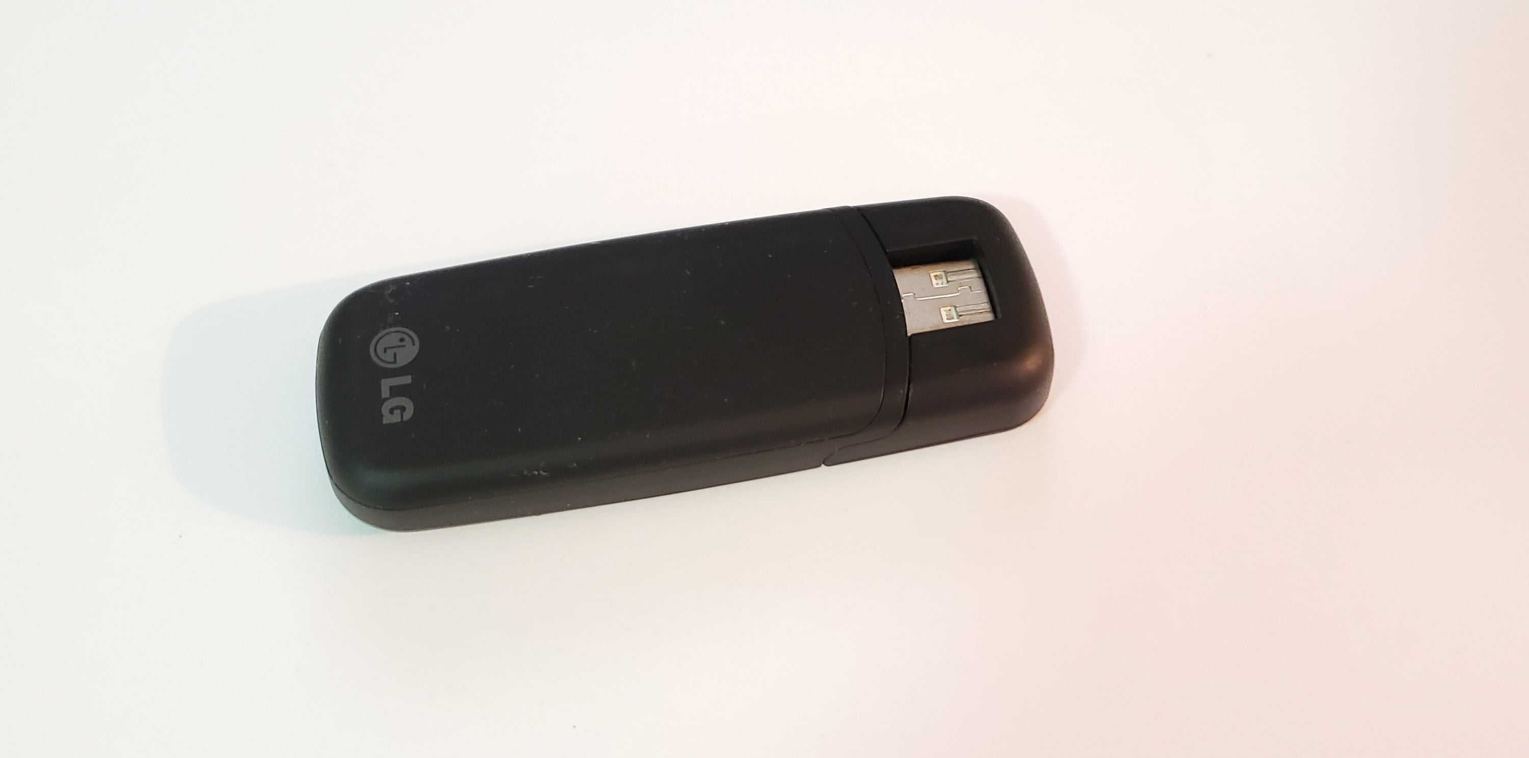Verizon LG VL600 4G USB Mobile Broadband Modem in black, showcasing its sleek design and USB connection.