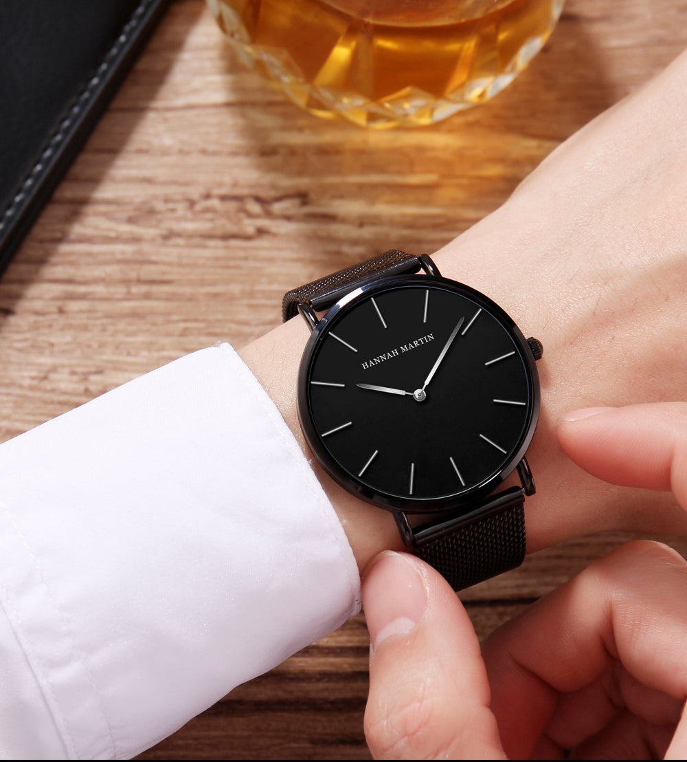 A stylish black watch featuring a waterproof Japan quartz movement and a stainless steel mesh band, perfect for men.