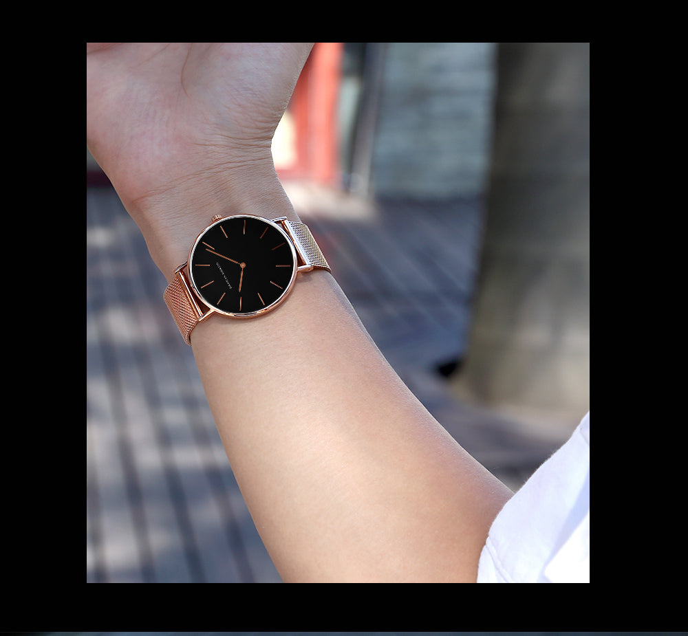 A stylish black watch featuring a waterproof Japan quartz movement and a stainless steel mesh band, perfect for men.