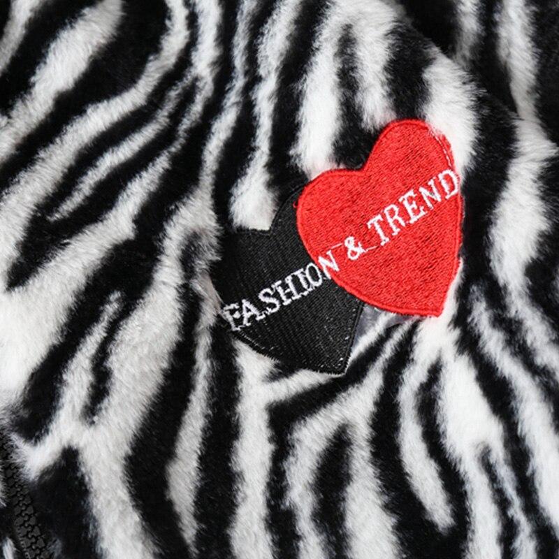 Men's winter jacket featuring heart embroidery and zebra striped print, designed for warmth and style.