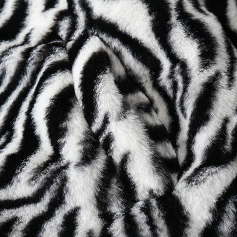 Men's winter jacket featuring heart embroidery and zebra striped print, designed for warmth and style.