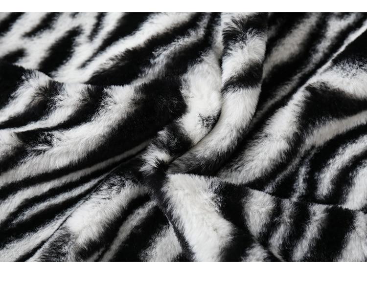 Men's winter jacket featuring heart embroidery and zebra striped print, designed for warmth and style.