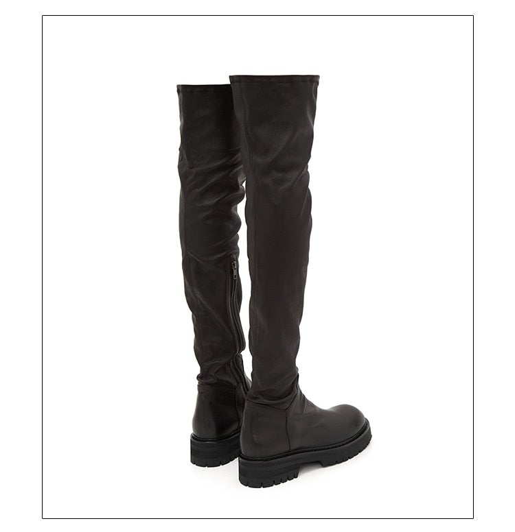 A pair of stylish black over-the-knee boots made from genuine leather, featuring a zipper closure and elastic design for a comfortable fit.