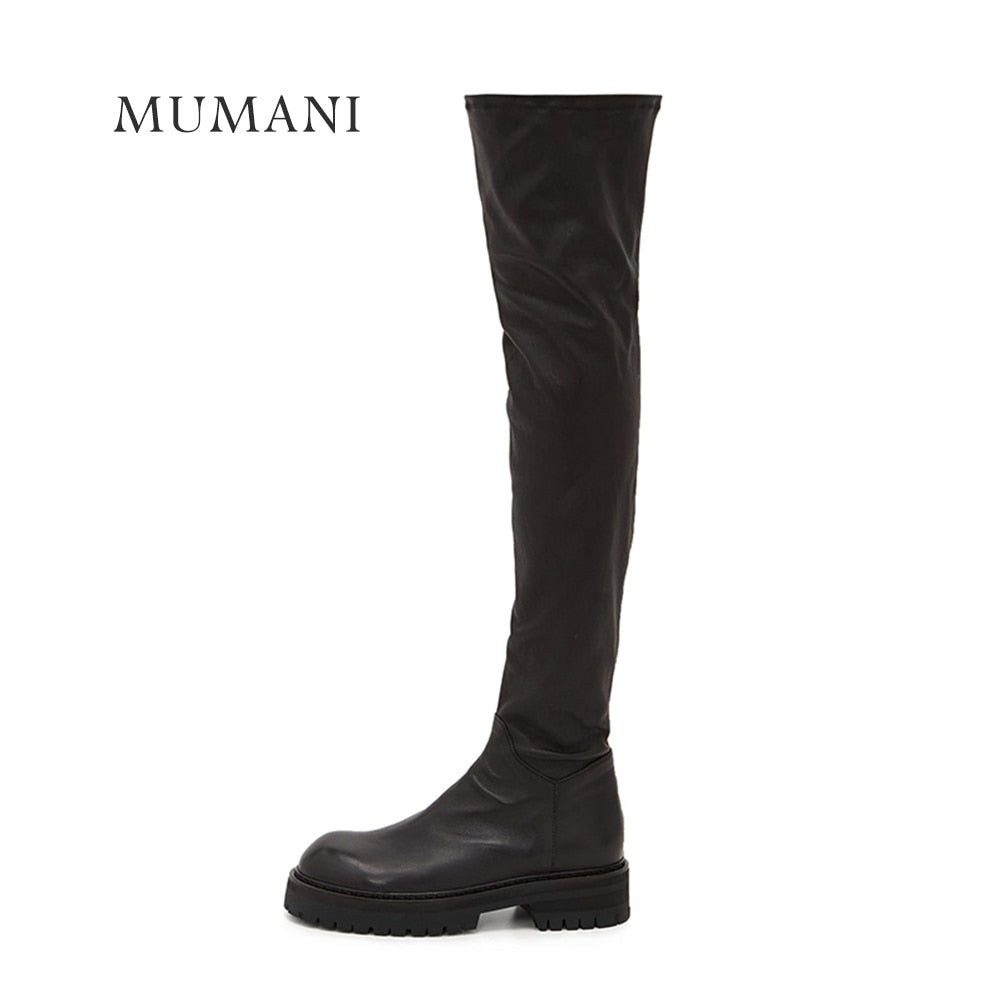 A pair of stylish black over-the-knee boots made from genuine leather, featuring a zipper closure and elastic design for a comfortable fit.