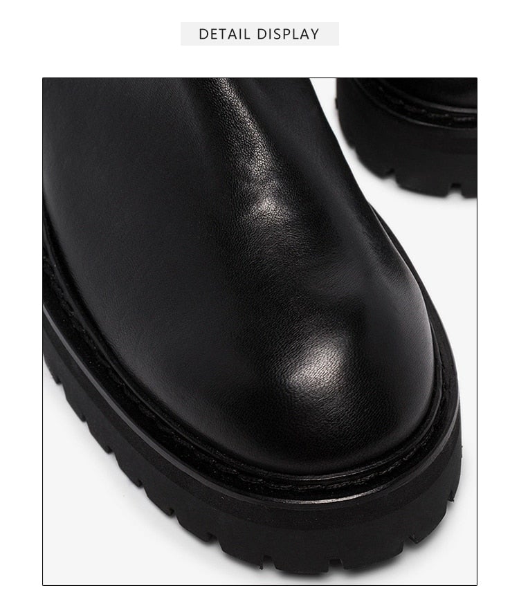 A pair of stylish black over-the-knee boots made from genuine leather, featuring a zipper closure and elastic design for a comfortable fit.