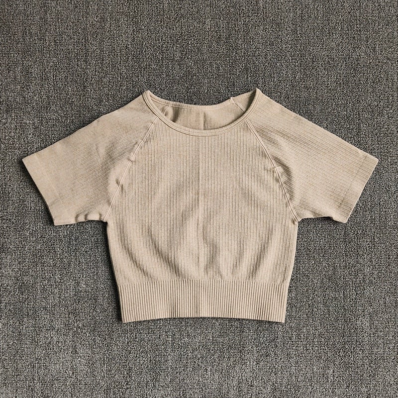 Women wearing a stylish short sleeve crop top yoga shirt in various colors, perfect for fitness and running.