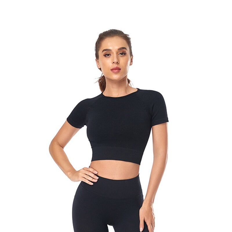 Women wearing a stylish short sleeve crop top yoga shirt in various colors, perfect for fitness and running.