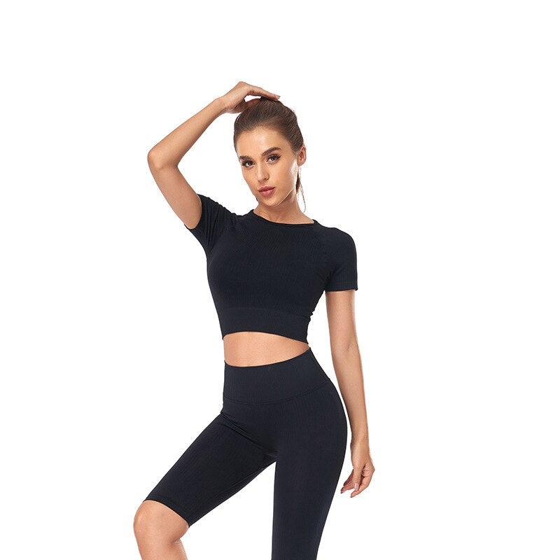Women wearing a stylish short sleeve crop top yoga shirt in various colors, perfect for fitness and running.