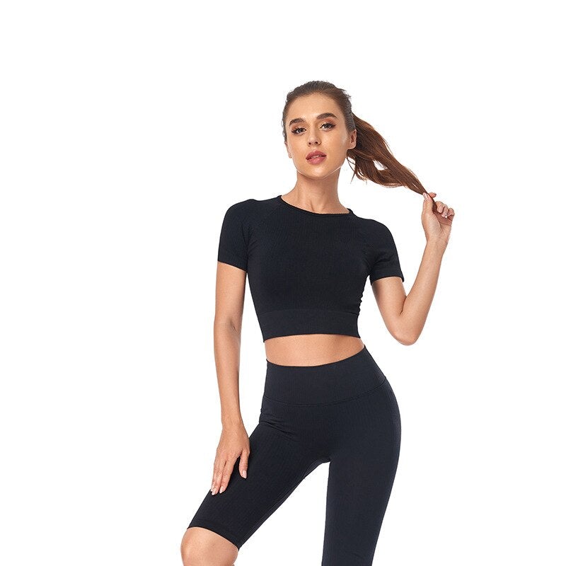 Women wearing a stylish short sleeve crop top yoga shirt in various colors, perfect for fitness and running.