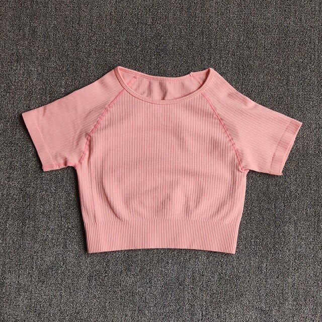 Women wearing a stylish short sleeve crop top yoga shirt in various colors, perfect for fitness and running.