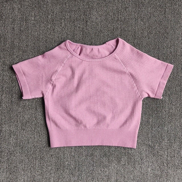 Women wearing a stylish short sleeve crop top yoga shirt in various colors, perfect for fitness and running.