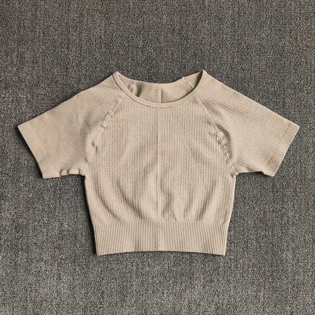 Women wearing a stylish short sleeve crop top yoga shirt in various colors, perfect for fitness and running.