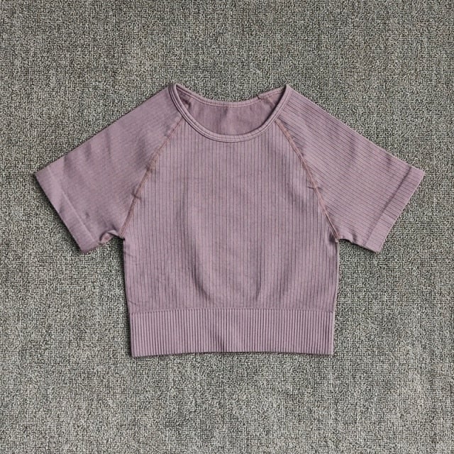 Women wearing a stylish short sleeve crop top yoga shirt in various colors, perfect for fitness and running.