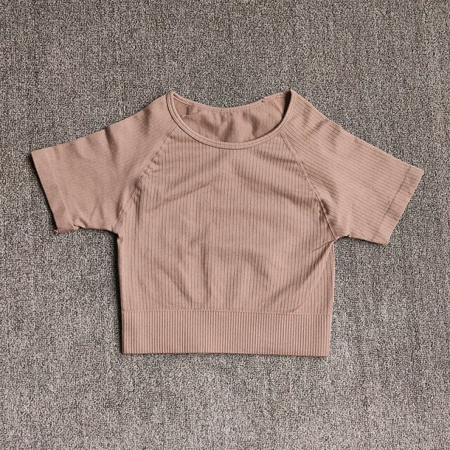 Women wearing a stylish short sleeve crop top yoga shirt in various colors, perfect for fitness and running.