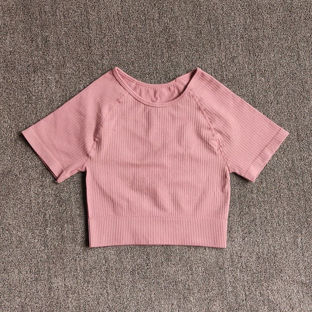 Women wearing a stylish short sleeve crop top yoga shirt in various colors, perfect for fitness and running.