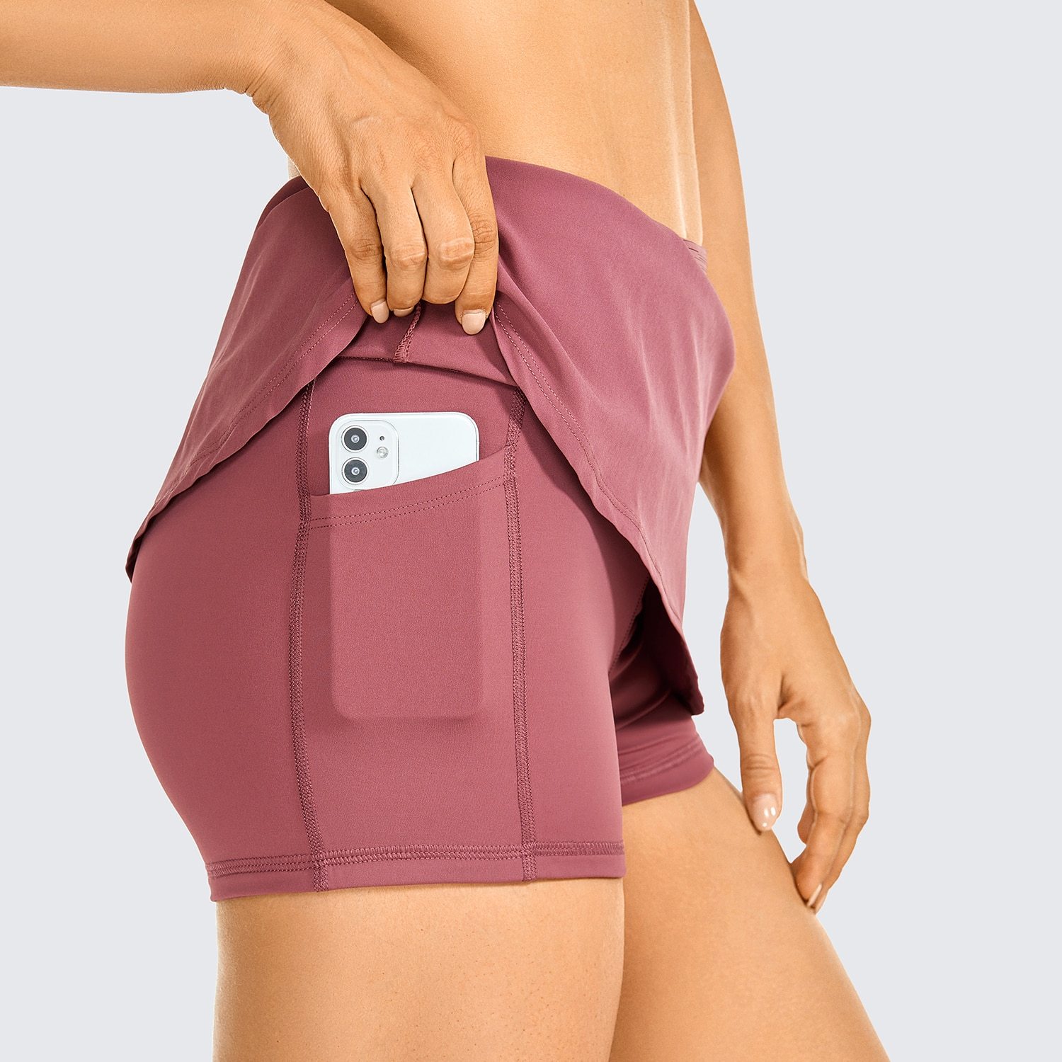 Women's lightweight athletic skorts in solid color with zipper pocket, perfect for tennis and golf.