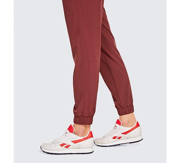 A pair of women's lightweight joggers pants in black with pockets and a drawstring elastic waist, perfect for athletic and casual wear.