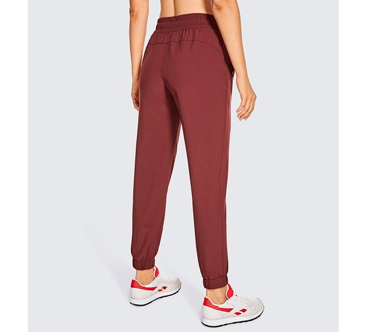 A pair of women's lightweight joggers pants in black with pockets and a drawstring elastic waist, perfect for athletic and casual wear.