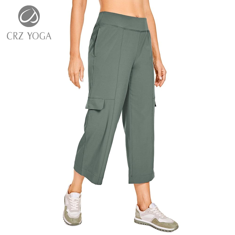A pair of women's lightweight loose wide leg capri joggers pants in brown with cargo pockets, showcasing a comfortable elastic waist and stylish design.