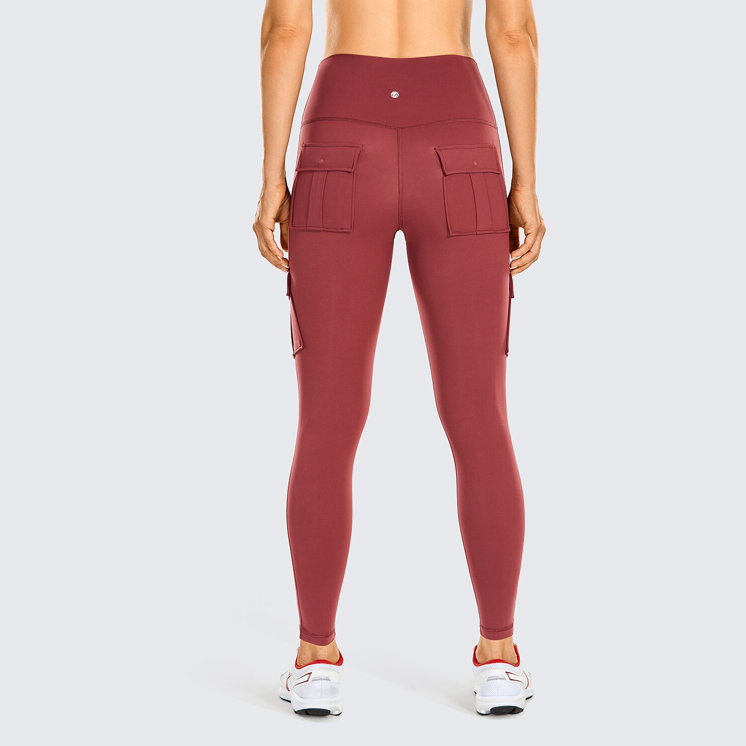 Women's high-waisted cargo workout leggings in black, featuring four pockets and a sleek design, perfect for yoga and running.